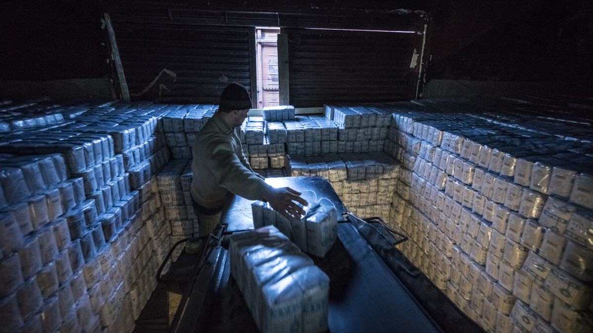 A worker loads packages of salt from a conveyor belt into a freight wagon for shipping at the Artemsol SE salt factory in Soledar, Ukraine, on Wednesday, Feb. 18, 2015. Ukraines worst recession since 2009 intensified last quarter, highlighting the nations challenge after sealing an expanded $17.5 billion bailout and agreeing on a truce in the war thats devastated its industrial base. Photographer: Vincent Mundy/Bloomberg via Getty Images