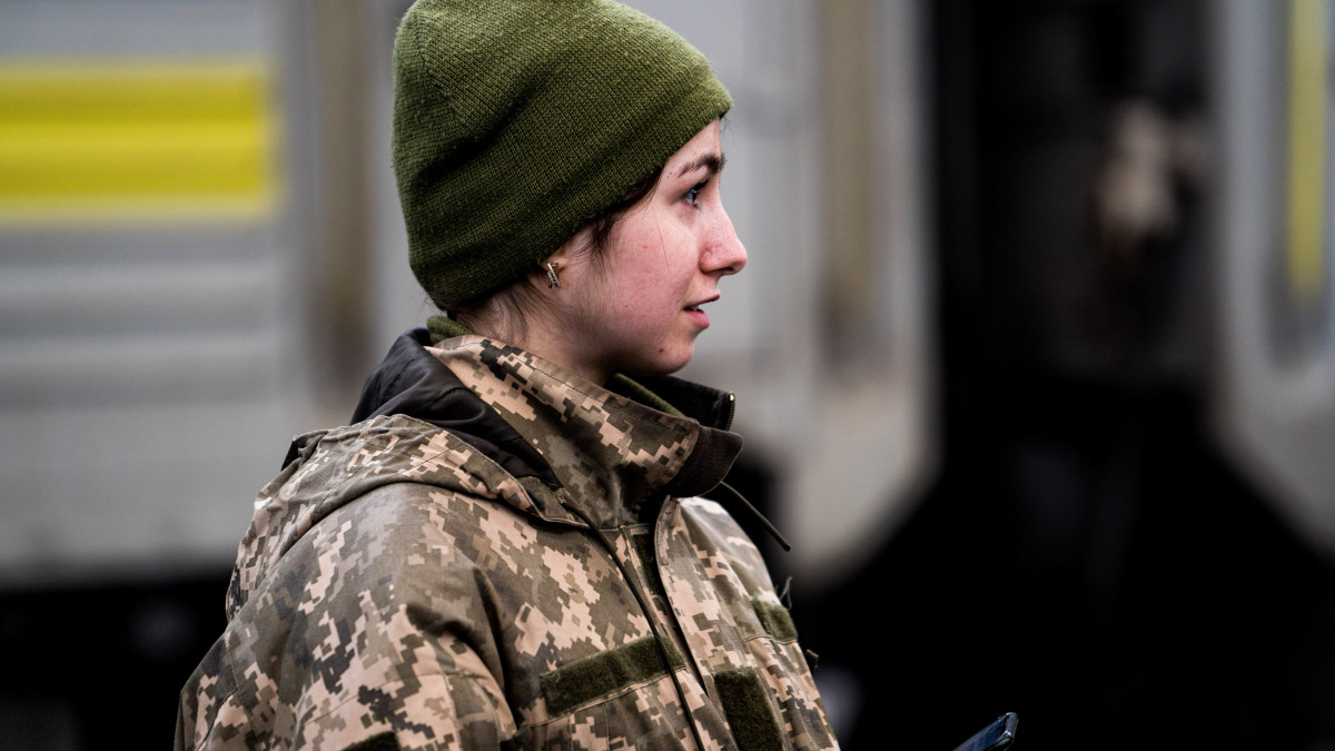 LVIV, UKRAINE - 2022/03/09: A woman soldier is at a train station as she waits for a train which will take her to the frontline.As Russia launched a full-scale invasion of Ukraine, people tried to escape the country, passing through Lviv, while others got ready to fight the Russian army. (Photo by Vincenzo Circosta/SOPA Images/LightRocket via Getty Images)