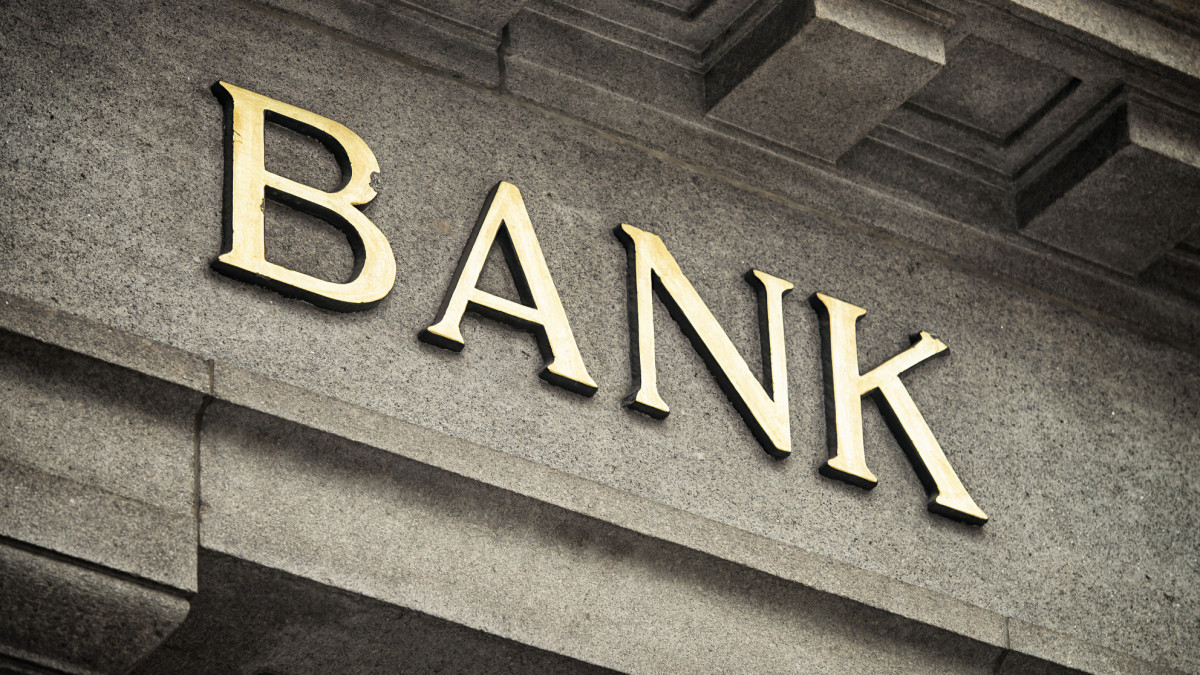 An old fashioned Bank sign on a building exterior.