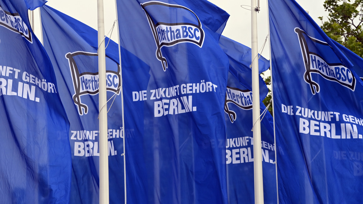 29 May 2022, Berlin: Soccer: Bundesliga, Hertha BSC, members meeting at Messe Berlin. Blue flags with the Hertha logo and the inscription The future belongs to Berlin are set up in front of the entrance to the exhibition halls. Photo: Soeren Stache/dpa (Photo by Soeren Stache/picture alliance via Getty Images)