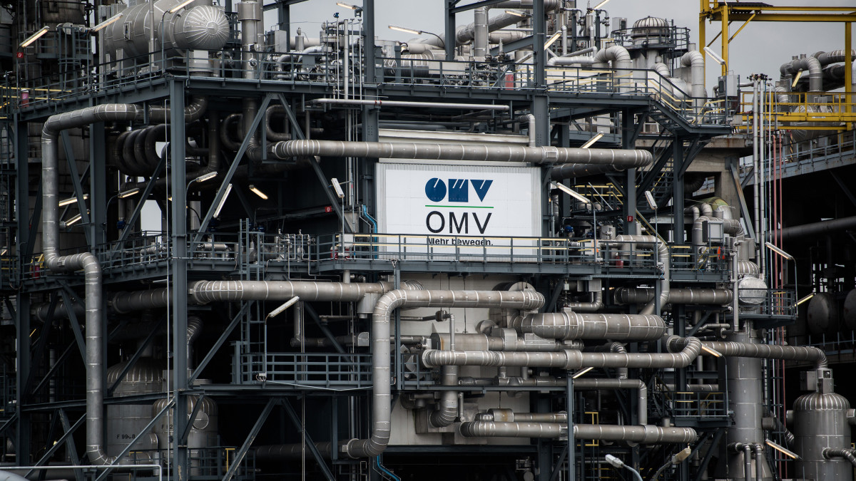 An OMV AG logo sits on the side of the ethylene plant at the OMV AG Schwechat oil refinery in Schwechat, Austria, on Wednesday, Oct. 21, 2015. OMV, Austrias state-controlled oil and gas company, wrote down its exploration and production assets by about 1 billion euros ($1.1 billion) citing the slump in crude prices. Photographer: Akos Stiller/Bloomberg via Getty Images