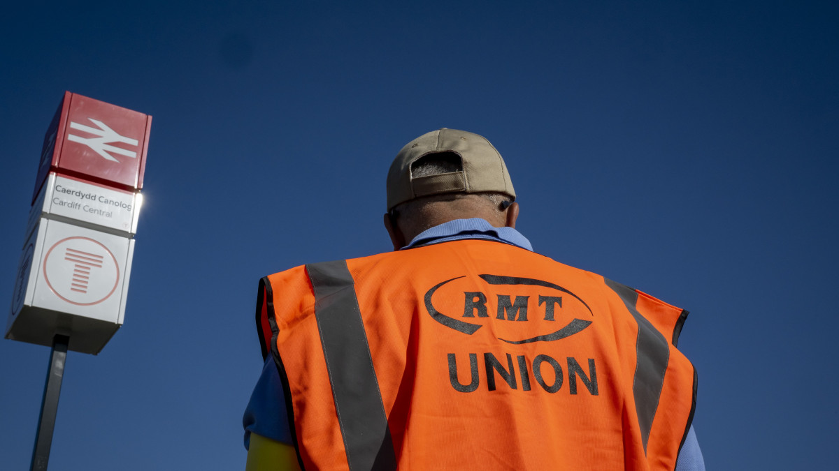 CARDIFF, WALES - JUNE 21: A man wearing an RMT Union jacket looks on at Cardiff Central Station on June 21, 2022 in Cardiff, Wales. The biggest rail strikes in 30 years started on Monday night with trains cancelled across the UK for much of the week. The action is being taken by Network Rail employees plus onboard and station staff working for 13 train operators across England. Thousands of jobs are at risk in maintenance roles and ticket office closures were planned as well as pay freezes during the cost of living crisis, says the RMT union. (Photo by Matthew Horwood/Getty Images)