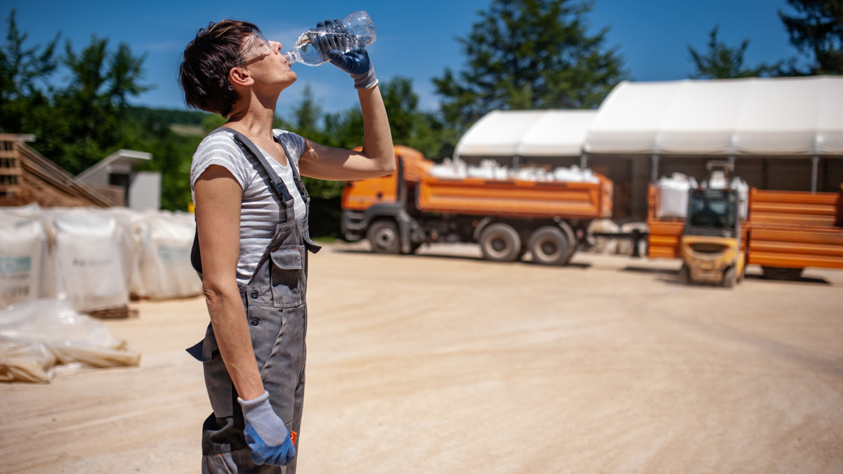 Thirsty Female Blue-collar Worker in Ore Processing Plant.