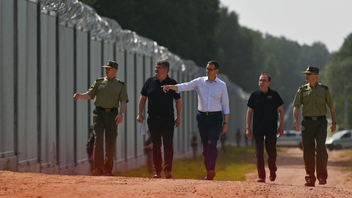 Prime Minister Mateusz Morawiecki (center) appeared on the Polish-Belarusian border at the border wall, which the Polish government called a physical barrier. He participated in the handover of this steel and concrete structure to the Border Guard, by the contractor of the project, Budimex, Unibep and Budrex companies. The border wall on the Polish-Belarusian border was built with the use of 50,000 tons of steel. It is 5.5 meters high,  topped with a razor wire and it stretches for 186.25 km.  On Thursday, June 30, 2022, in Nowodziel, near Kuznica, Podlaskie Voivodeship, Poland. (Photo by Artur Widak/NurPhoto via Getty Images)