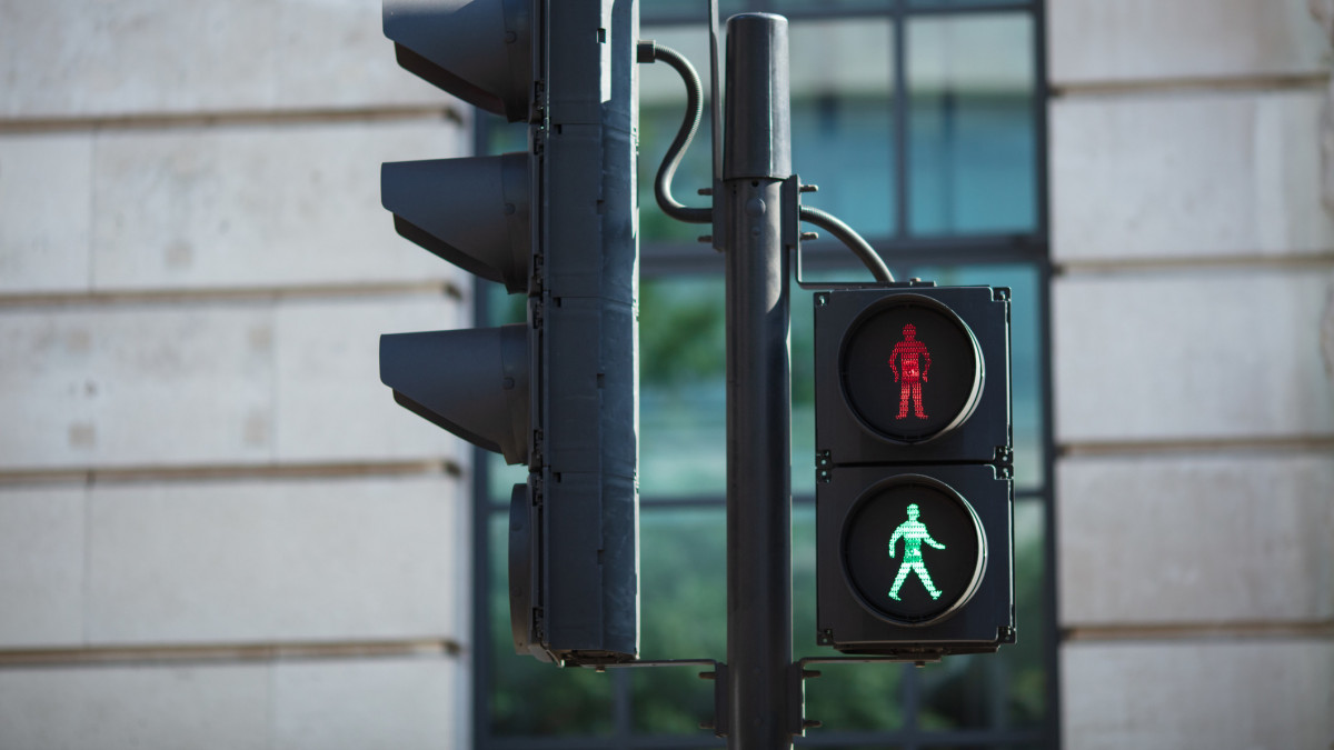 Pedestrian crossing lights with walk and stop symbols