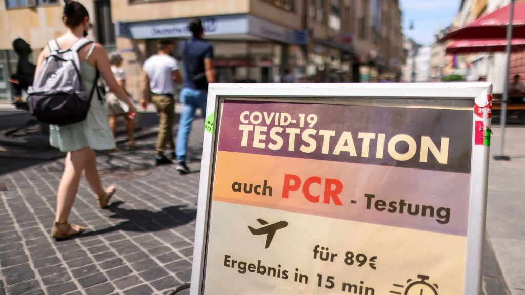 20 July 2022, Saxony-Anhalt, Halle: Passers-by walk past a test station at a pharmacy on Leipziger StraĂe. Photo: Jan Woitas/dpa (Photo by Jan Woitas/picture alliance via Getty Images)