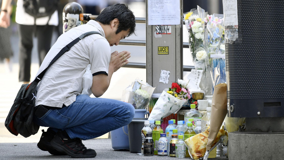 A man prays at the site of a 2008 stabbing rampage in Tokyos Akihabara area on June 8, 2021, the 13th anniversary of the incident in which seven people died and 10 others were injured. (Photo by Kyodo News via Getty Images)