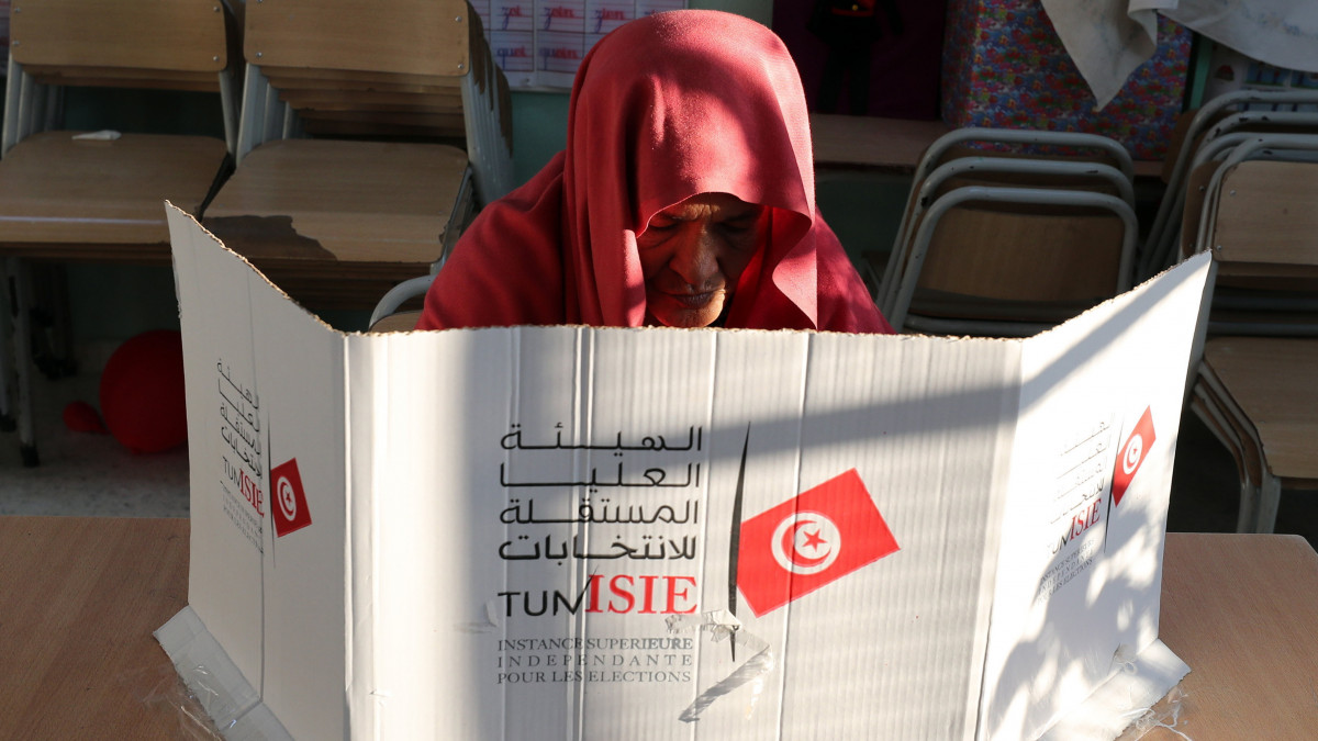 Nő voksol az alkotmánymódosításról tartott népszavazáson Tuniszban 2022. július 25-én. Az ellenzéki pártok és a fő szakszervezet a szavazás bojkottálására szólított fel, ezért alacsony részvétel és az igenek győzelme valószínűsíthető.