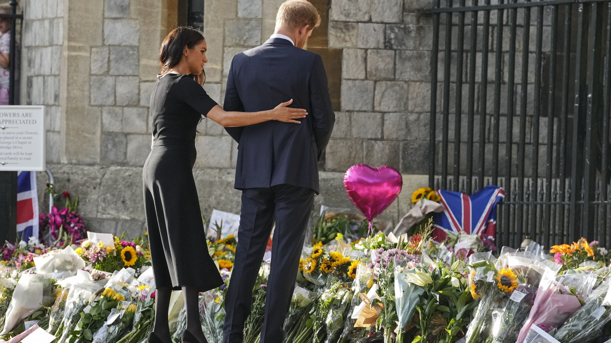 Harry herceg és a felesége, Meghan sussexi hercegnő megnézi a windsori kastély elé kegyeletből elhelyezett virágokat 2022. szeptember 10-én. Harry nagyanyja, II. Erzsébet brit királynő két nappal korábban, 96 éves korában, uralkodásának 71. évében elhunyt.