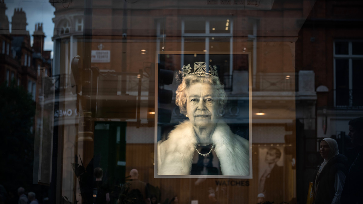 LONDON, ENGLAND - SEPTEMBER 15: A portrait of Queen Elizabeth II is displayed as a tribute in the window of a department store on September 15, 2022 in London, United Kingdom. Queen Elizabeth II is lying in state at Westminster Hall until the morning of her funeral to allow members of the public to pay their last respects. Elizabeth Alexandra Mary Windsor was born in Bruton Street, Mayfair, London on 21 April 1926. She married Prince Philip in 1947 and acceded to the throne of the United Kingdom and Commonwealth on 6 February 1952 after the death of her Father, King George VI. Queen Elizabeth II died at Balmoral Castle in Scotland on September 8, 2022, and is succeeded by her eldest son, King Charles III. (Photo by Carl Court/Getty Images)