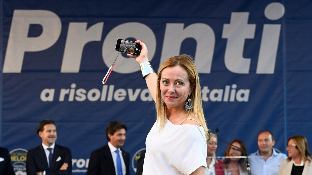 Giorgia Meloni, leader of the far-right Brothers of Italy party, takes a selfie during a rally in Duomo square ahead of the Sept. 25 snap election, in Milan, Italy, September 11, 2022. REUTERS/Flavio Lo Scalzo