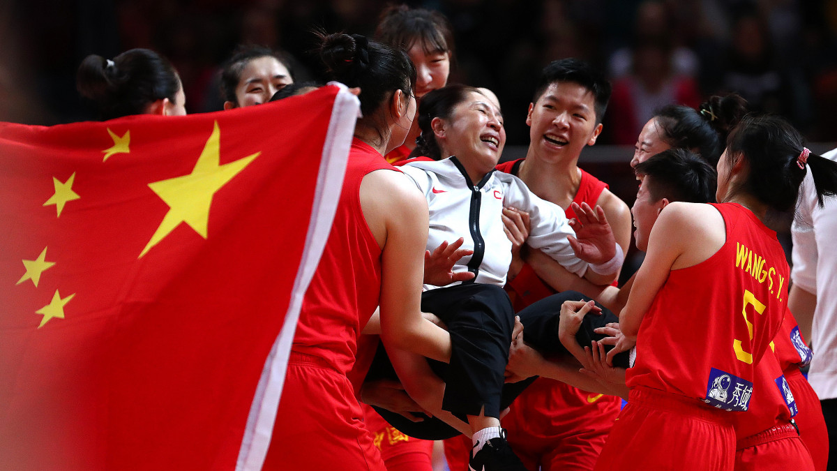SYDNEY, AUSTRALIA - SEPTEMBER 30: China players hoist Wei Zheng head coach of China in the air following during the 2022 FIBA Womens Basketball World Cup Semi Final match between Australia and China at Sydney Superdome, on September 30, 2022, in Sydney, Australia. (Photo by Kelly Defina/Getty Images)