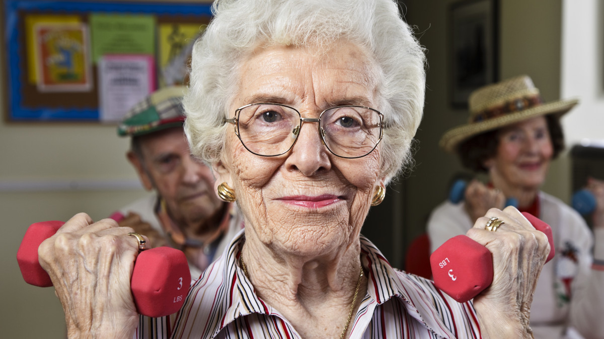 Senior citizens in a retirement home exercise room.