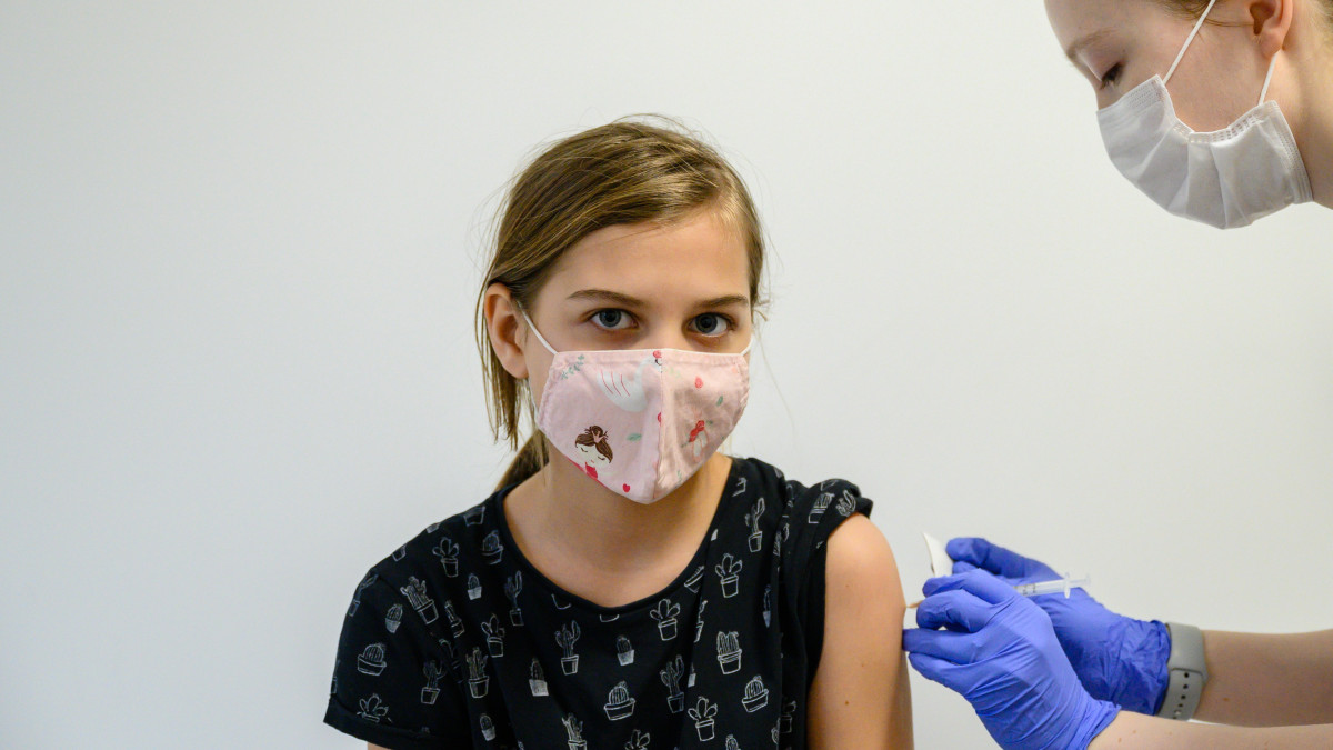 Beoltanak egy lányt a német-amerikai fejlesztésű Pfizer-BioNTech koronavírus elleni oltóanyag, a Comirnaty-vakcina gyermekek oltására alkalmas változatának második adagjával a Fejér Megyei Szent György Egyetemi Oktató Kórházban 2022. február 11-én.