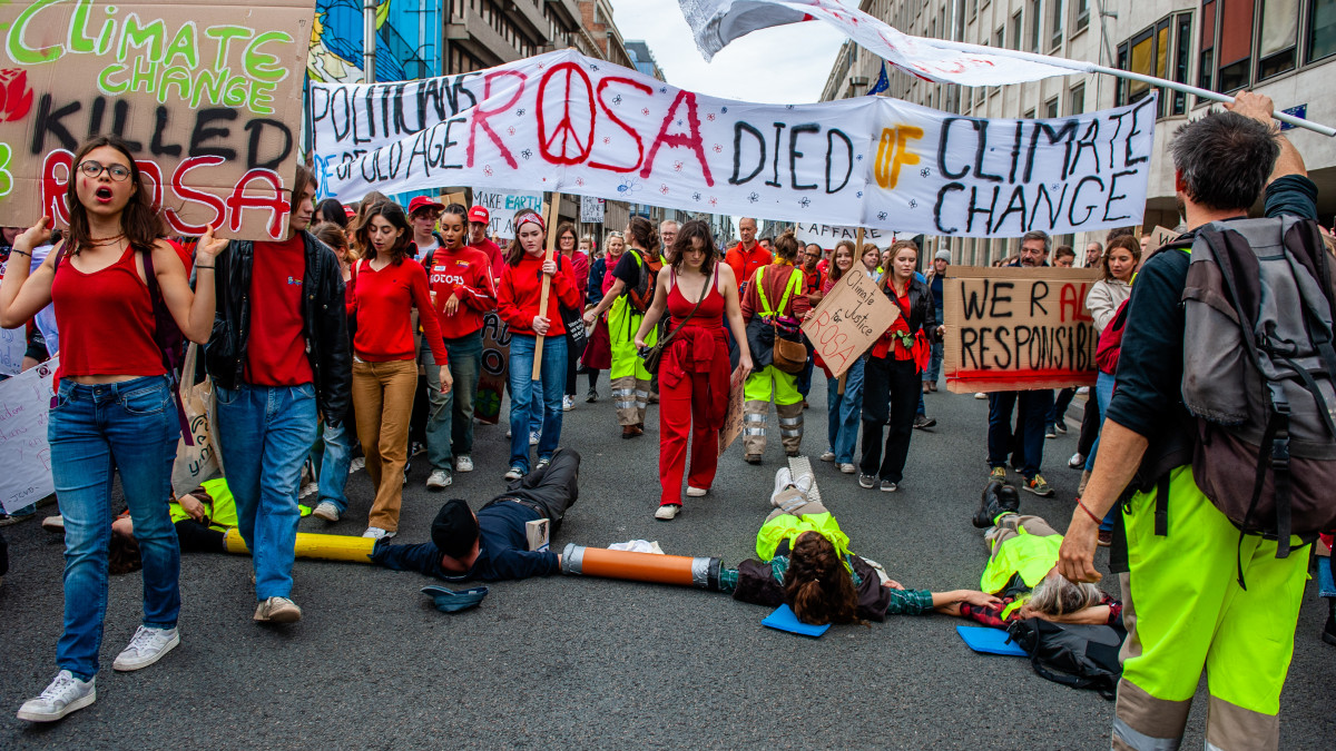 Climate activists are laying on the ground blocking the street, during a massive climate demonstration organized in Brussels, on October 23rd, 2022. (Photo by Romy Arroyo Fernandez/NurPhoto via Getty Images)