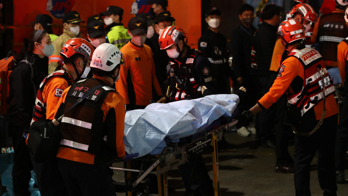 SEOUL, SOUTH KOREA - OCTOBER 30: Emergency services transport a person after a stampede during a Halloween celebration October 30, 2022 in Seoul, South Korea. Fifty-nine people have been reported killed and at least 150 others were injured in a deadly stampede in Seouls Itaewon district, after huge crowds of people gathered at Halloween parties, according to fire authorities. (Photo by Chung Sung-Jun/Getty Images)