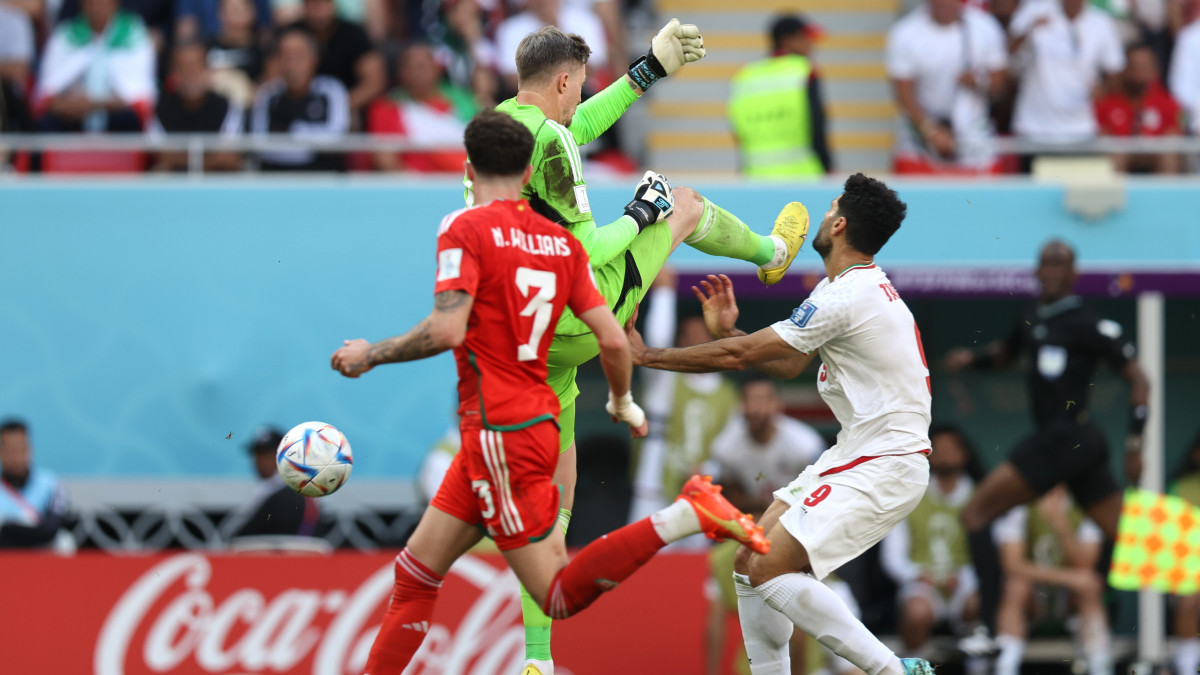 DOHA, QATAR - NOVEMBER 25: Wales goalkeeper Wayne Hennessey fouls Mehdi Taremi of Iran and is given a red card during the FIFA World Cup Qatar 2022 Group B match between Wales and IR Iran at Ahmad Bin Ali Stadium on November 25, 2022 in Doha, Qatar. (Photo by Charlotte Wilson/Offside/Offside via Getty Images)