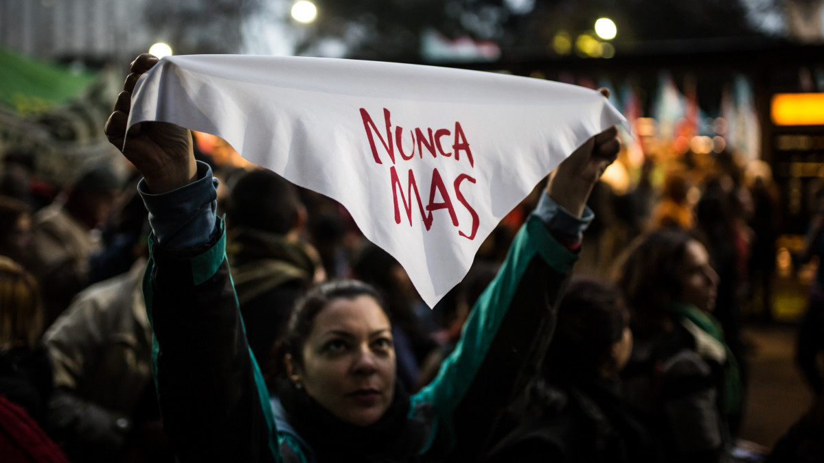 26 July 2018, Argentina, Buenos Aires: A demonstrator holds a white cloth with the inscription Nunca mas (Never again) during a demonstration against the military reform of the country planned by the government. President Macris government plans to involve the armed forces in internal security matters. Photo: Nicolas Villalobos/dpa (Photo by Nicolas Villalobos/picture alliance via Getty Images)