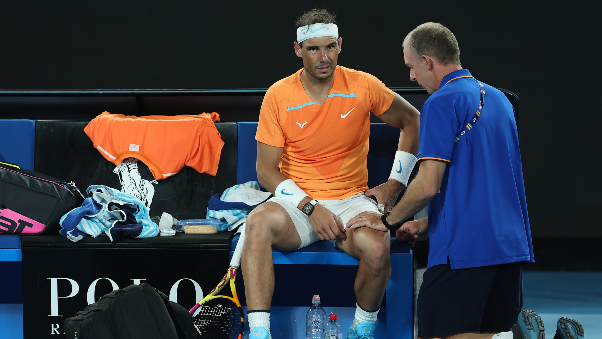 MELBOURNE, AUSTRALIA - JANUARY 18: Rafael Nadal of Spain receives attention during a medical time out in their round two singles match against Mackenzie McDonald of the United States during day three of the 2023 Australian Open at Melbourne Park on January 18, 2023 in Melbourne, Australia. (Photo by Cameron Spencer/Getty Images)