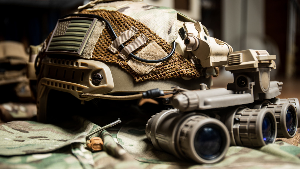 Special Forces FAST helmet with US flag equipped with panorama night vision goggles on a multicam pattern uniform.