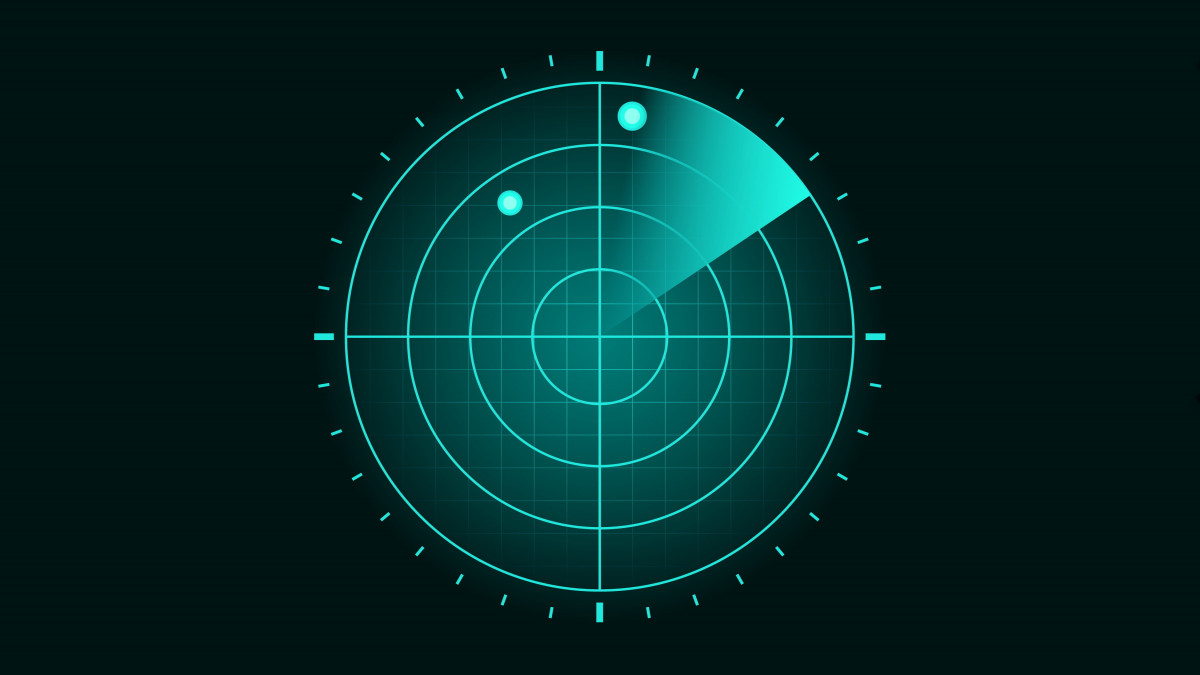 Blue military radar screen with grid coordinates and positioning. The scanner axis is spinning around the center and a detected object (plane or missile) is observed on the top half.