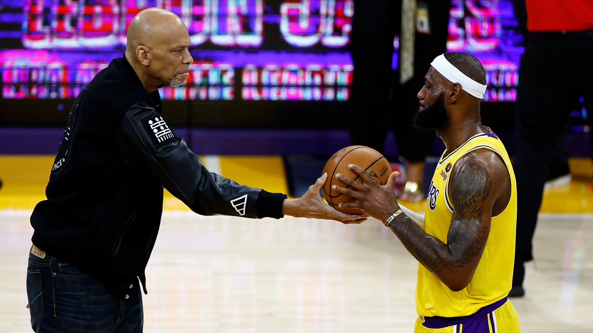 LOS ANGELES, CALIFORNIA - FEBRUARY 07: Kareem Abdul-Jabbar ceremoniously hands LeBron James #6 of the Los Angeles Lakers the ball after James passed Abdul-Jabbar to become the NBAs all-time leading scorer, surpassing Abdul-Jabbars career total of 38,387 points against the Oklahoma City Thunder at Crypto.com Arena on February 07, 2023 in Los Angeles, California. NOTE TO USER: User expressly acknowledges and agrees that, by downloading and or using this photograph, User is consenting to the terms and conditions of the Getty Images License Agreement. (Photo by Ronald Martinez/Getty Images)