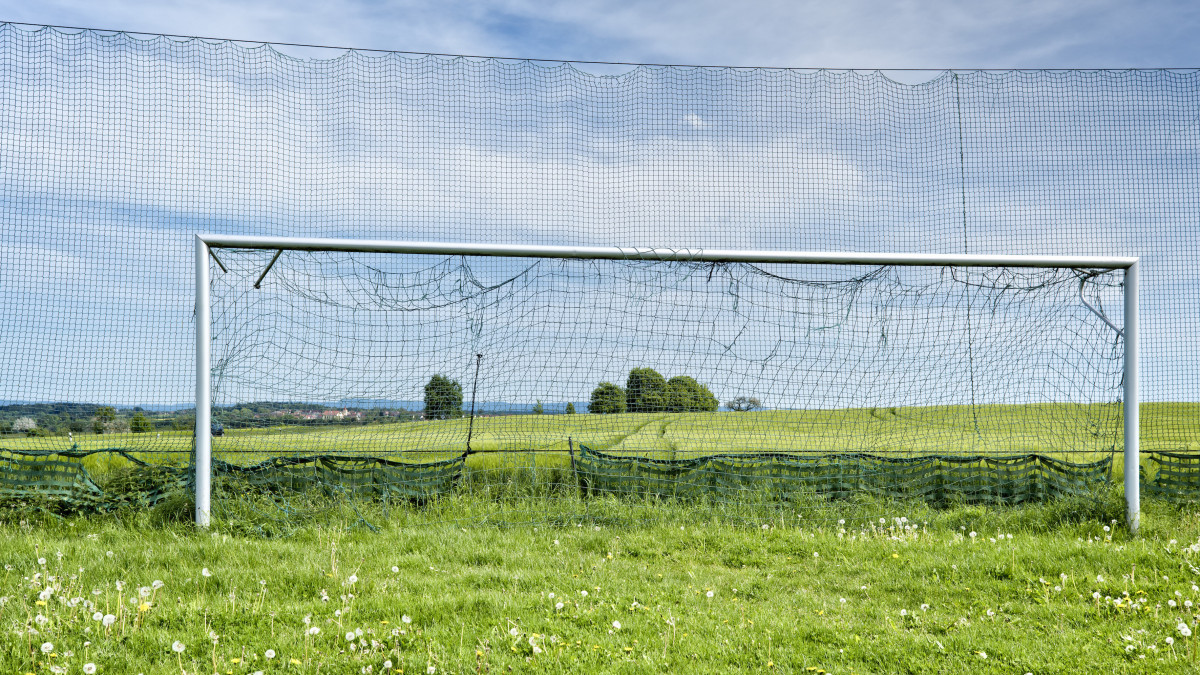 Worn Soccer goal in the countryside