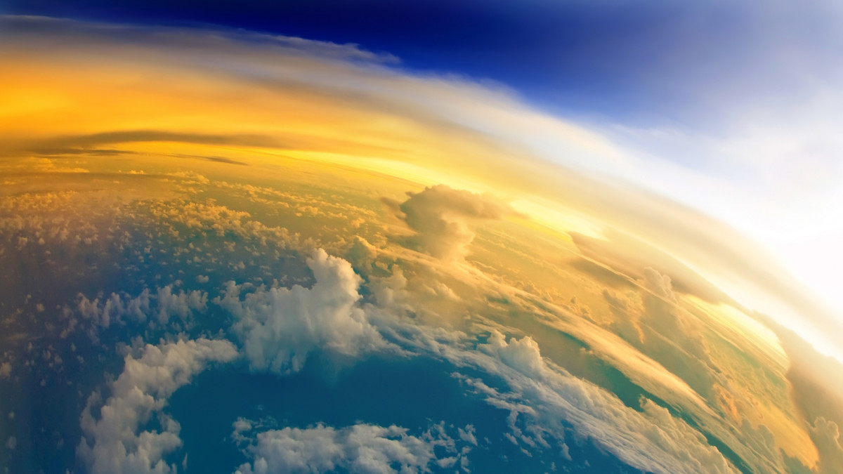 Aerial view of Planet Earth with clouds, horizon and little bit of space, make feelings of being in heaven. Dramatic clouds and orange sunlight all over the planet. Cloudscape and stratosphere from above at 30000 feet.See more images like this in: