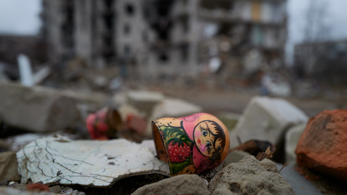 IZYUM, UKRAINE - DECEMBER 27: A Russian Matryoshka doll lays on rubles outside a bombed residential building on December 27, 2022 in Izyum, Ukraine. (Photo by Pierre Crom/Getty Images)