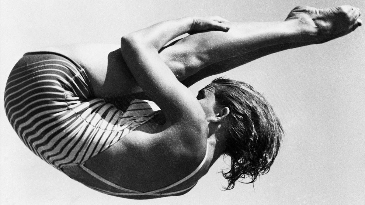 (Original Caption) 7/30/1952-Helsinki, Finland- OLYMPICS GAMES. Mrs. Patricia McCormick of Los Angeles, CA, shows off her championship form as she executes a difficult manuever on the Olympic springboard in Helsinki. Mrs. McCormicks form won her the springboard diving title and the gold medal which accompanies the title.