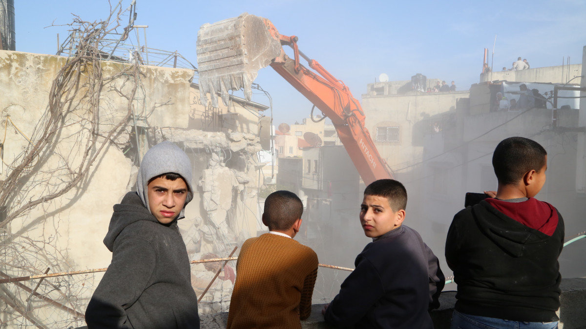 JENIN, WEST BANK - JANUARY 31: A heavy duty machine demolishes a house damaged by a rocket launcher during a raid carried out by the Israeli forces on Jan. 26, in Jenin, West Bank on January 31, 2023. The traces of the fire caused by the impact of the explosion, the damage to the walls and columns, reveal the severity of the attack. (Photo by Enes Canli/Anadolu Agency via Getty Images)