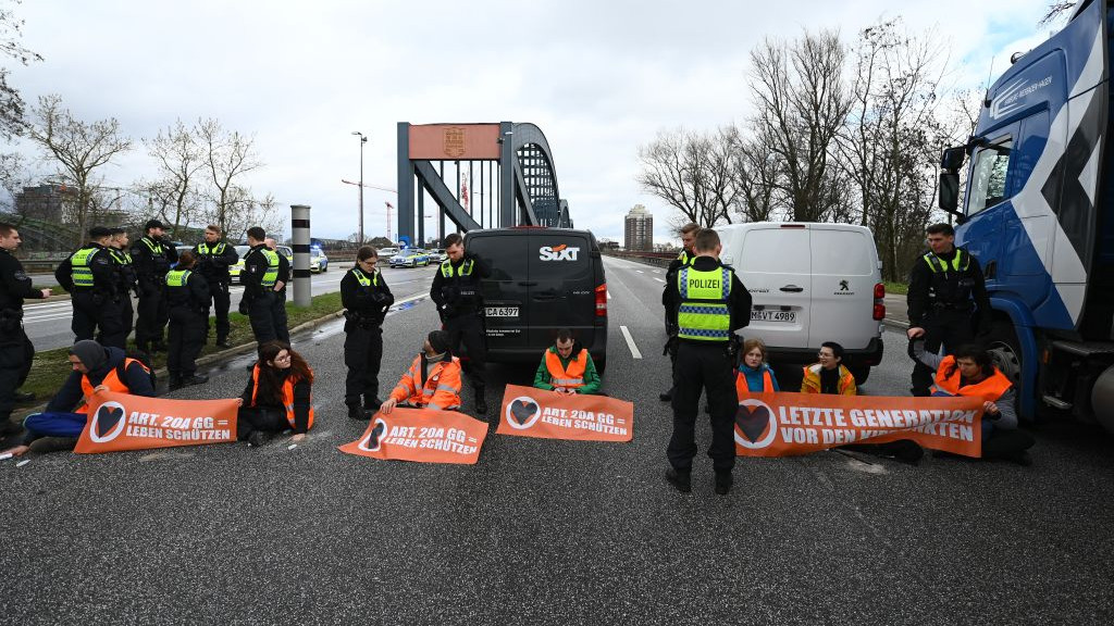 25 March 2023, Hamburg: Climate activists from the Last Generation movement blocked the Elbe bridges in the city on Saturday. According to police, four people stuck themselves to the road with quick-setting concrete in the morning. Photo: Jonas Walzberg/dpa (Photo by Jonas Walzberg/picture alliance via Getty Images)