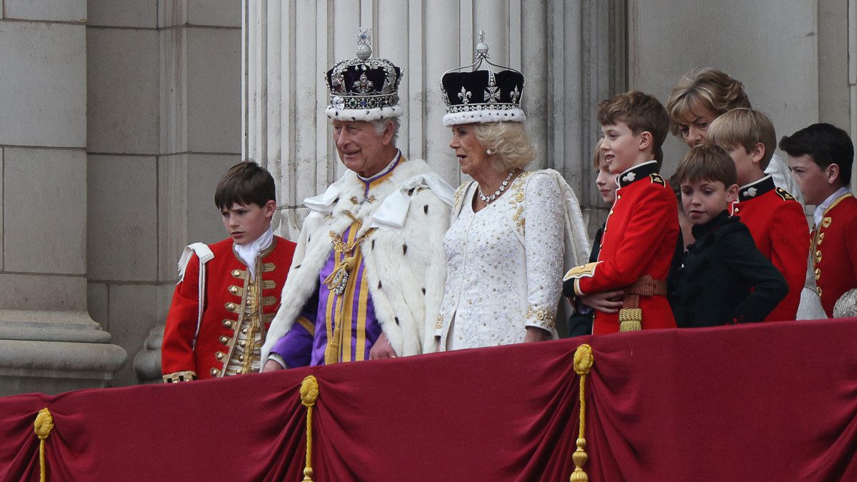 LONDON, ENGLAND - MAY 06: Britains King Charles III wearing the Imperial state Crown, and Britains Queen Camilla wearing a modified version of Queen Marys Crown look on from the Buckingham Palace balcony while viewing the Royal Air Force fly-past the coronation on May 06, 2023 in London, England. The Coronation of Charles III and his wife, Camilla, as King and Queen of the United Kingdom of Great Britain and Northern Ireland, and the other Commonwealth realms takes place at Westminster Abbey today. Charles acceded to the throne on 8 September 2022, upon the death of his mother, Elizabeth II. (Photo by Adrian Dennis - WPA Pool/Getty Images)