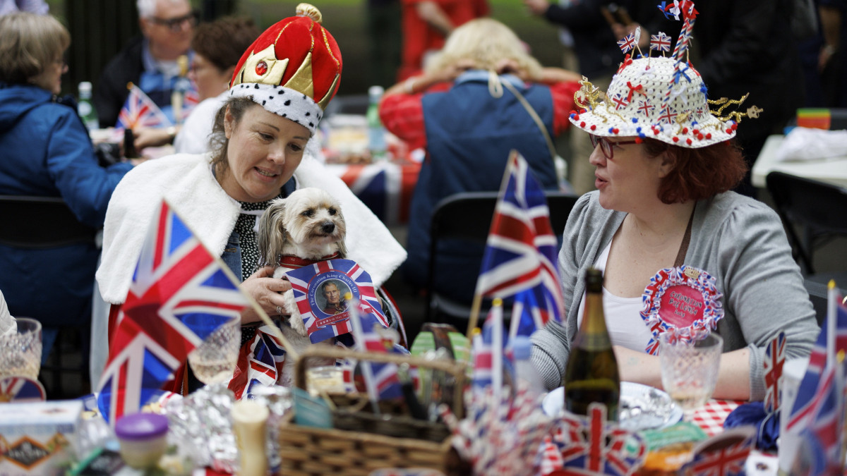 Emberek a londoni Regents Parkban tartott utcabálon 2023. május 7-én, III. Károly brit király koronázási ünnepségének másnapján. Nagy-Britanniában a koronázás alkamából országszerte több tízezer helyi utcabált rendeznek milliók részvételével.
