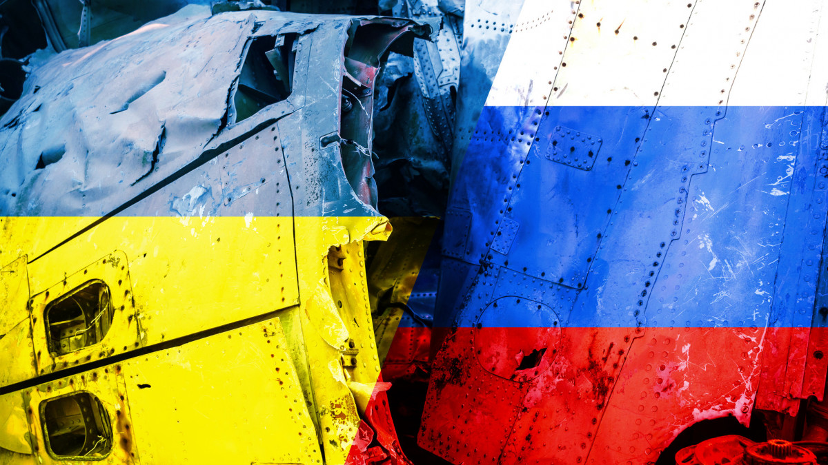 Russia Ukraine Conflict Concept - Russian and Ukrainian Flags overlaying close up of war Military damage, destroyed tank and aircraft scraps in a pile
