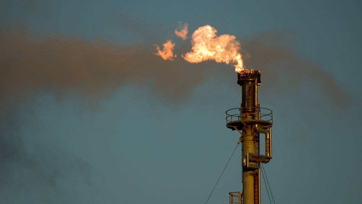 A flare burns waste gas at an oil Refinery.