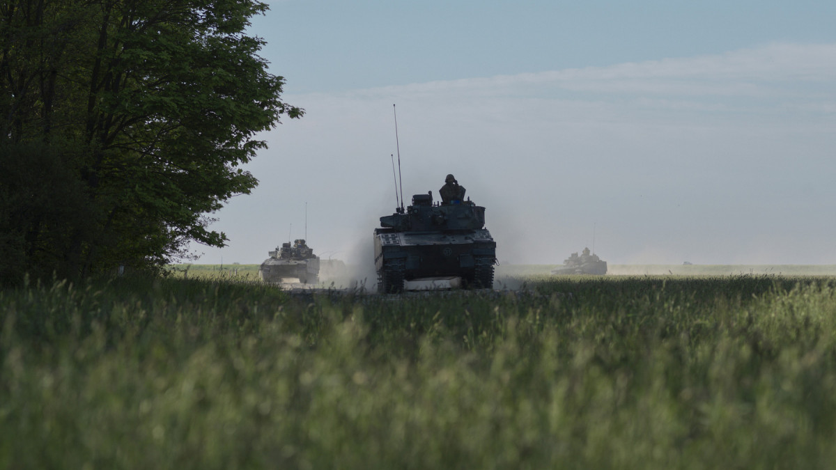 infantry fighting vehicle driving through field during military exercise (CV90)