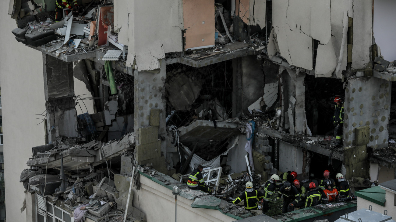 A mentőalakulat tagjai a legutóbbi orosz légitámadásban súlyosan megrongálódott lakóházak egyikében 2023. június 24-én. Az orosz erők több mint húsz rakétát lőttek ki az ukrán fővárosra hajnalban, aminek következtében hárman életüket vesztették és legalább tizenegyen megsebesültek.