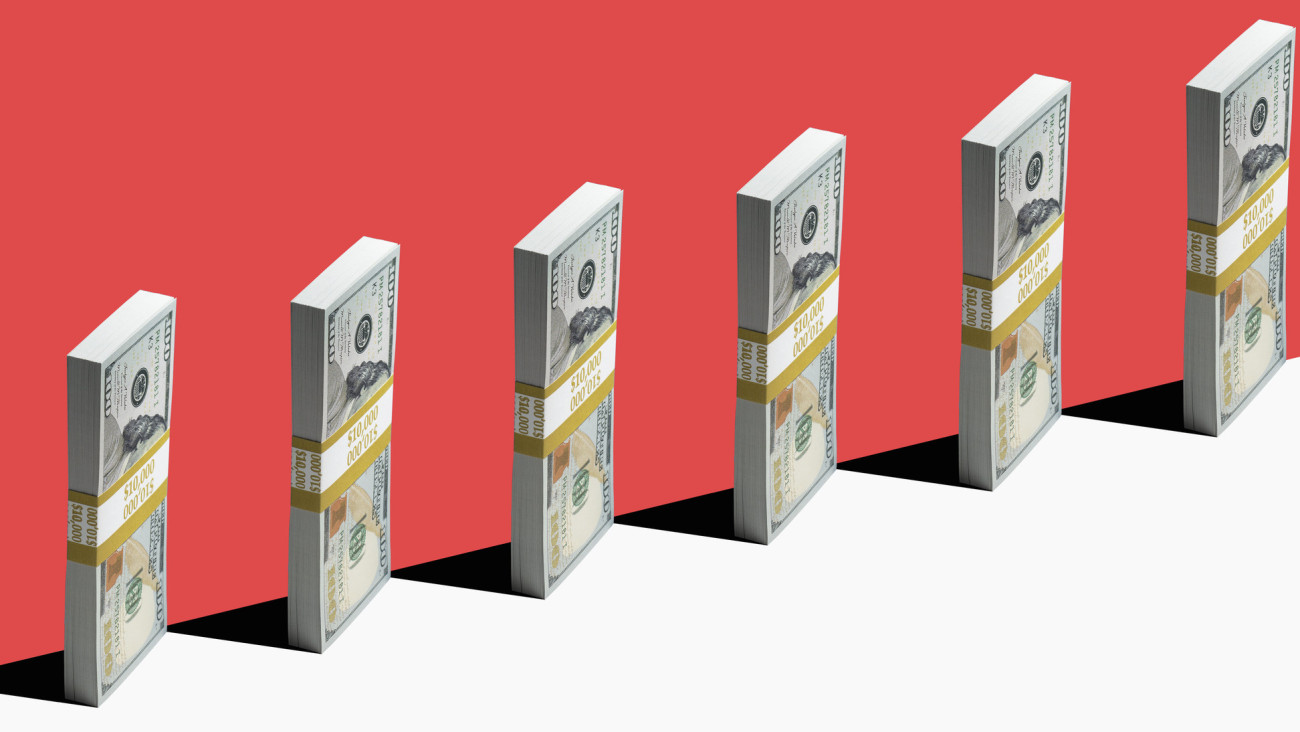 6 bundles of US $100 bills standing vertically on edge of white shelf, red background