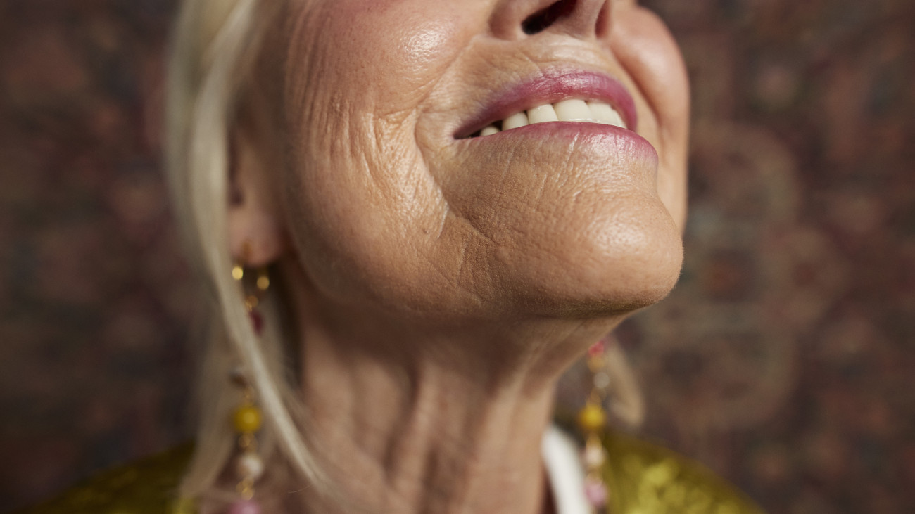 Close-up of midsection of smiling senior woman
