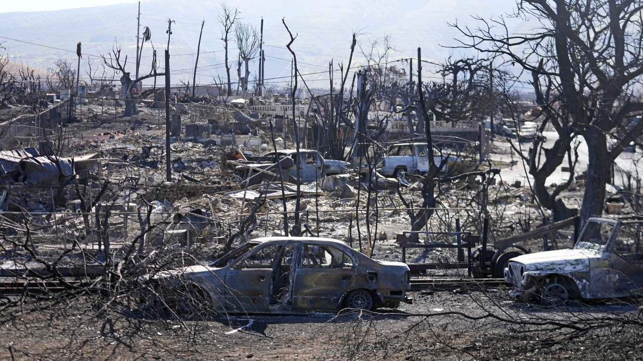 Erdőtűzben megsemmisült épületek és autók a hawaii Maui-szigeten fekvő Lahainában 2023. augusztus 13-án. Az előző napok tűzvésze legalább 93 ember halálát okozta, több száz eltűnt után még kutatnak. Lahaina, az egykori Hawaii Királyság fővárosa szinte teljesen elpusztult az Egyesült Államok utóbbi száz évének legsúlyosabb erdőtüzében.