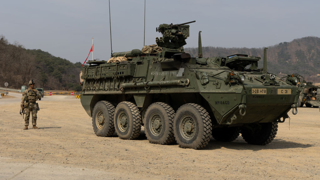 A U.S. soldier from the 2nd Infantry Division, Stryker Battalion, next to an armored vehicle ahead of a joined live-fire exercise with South Korean army at Rodriguez Range in Pocheon, South Korea, on Wednesday, March 22, 2023. South Koreas defense ministry said in a statement Wednesday that the country plans to hold its largest-ever live-fire drills with the US in June in a move certain to anger North Korea, which has ramped up its provocations to new levels in response to recent military exercises. Photographer: SeongJoon Cho/Bloomberg via Getty Images