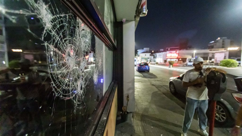 The front glass of the store is seen shattered, as protesters attacked the hair salon that belongs to a migrant, Limassol, Cyprus, on Sep. 2, 2023. Damages took place during an anti-migrant protest that was organized through social media, where police and protesters clashed, with police using tear gas and flash bombs and protesters throwing molotov cocktail bombs. Protesters attacked some stores that belong to migrants. The protest followed the protests and clashes that took place in Xloraka, in Pafos district the previous days, where there are many irregular migrants.  (Photo by Kostas Pikoulas/NurPhoto via Getty Images)