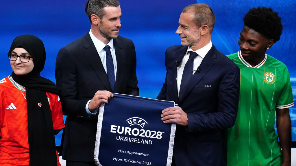 Wales delegate Gareth Bale and UEFA president Aleksander Ceferin hold a UEFA Euro 2028 pennant during the Euro 2028 and Euro 2032 hosts announcement ceremony at the UEFA Headquarters in Nyon, Switzerland. The UK and Ireland will host Euro 2028, UEFA has confirmed. Picture date: Tuesday October 10, 2023. (Photo by Mike Egerton/PA Images via Getty Images)