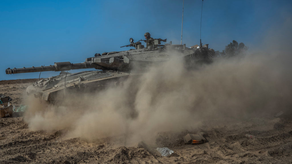14 October 2023, Israel, Beeri: A tank moves through the area near Kibbutz Beeri by the Israeli-Gaza border, as fighting between Israeli troops and Islamist Hamas militants continues. Photo: Ilia Yefimovich/dpa (Photo by Ilia Yefimovich/picture alliance via Getty Images)