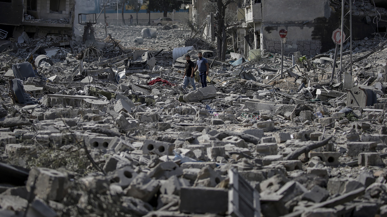 Két palesztin férfi nézi az egyik izraeli légitámadásban megsemmisült házak romjait Gázában 2023. október 10-én. A Gázai övezetet irányító Hamász palesztin iszlamista szervezet október 7-én többfrontos támadást indított Izrael ellen, mintegy 900 izraeli életét vesztette, a Hamász elleni izraeli válaszcsapások halálos áldozatainak száma a Gázai övezetben 700-hoz közelít.