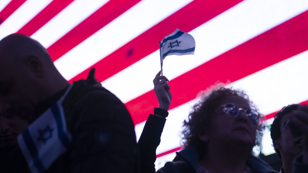 Résztvevők az Izrael mellett tartott szolidaritási tüntetésen a New York-i Times Square-en 2023. október 19-én. A Gázai övezetet irányító Hamász palesztin iszlamista terrorszervezet október 7-én betört az övezet melletti izraeli településekre, ahol megöltek több mint 1400 embert, háromezret megsebesítettek és elhurcoltak mintegy kétszáz civilt. A Hamász elleni izraeli hadművelet eddig közel 3500 palesztin halálát okozta a Gázai övezetben, a sebesültek száma túllépte 12 ezret.