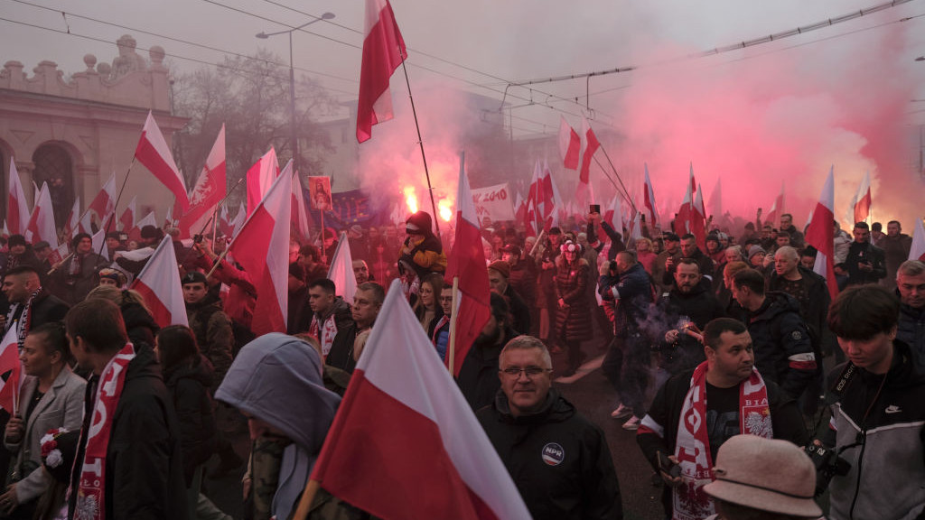 Attendees carry national flags during a march to mark the 105th anniversary of Polish independence at the Dmowski Roundabout in Warsaw, Poland, on Saturday, Nov. 11, 2023. Polands pro-European Union opposition underÂ Donald TuskÂ signed a deal to form a government, taking the allies a step closer to power as they seek to steer the country back into the blocs fold. Photographer: Damian Lemanski/Bloomberg via Getty Images