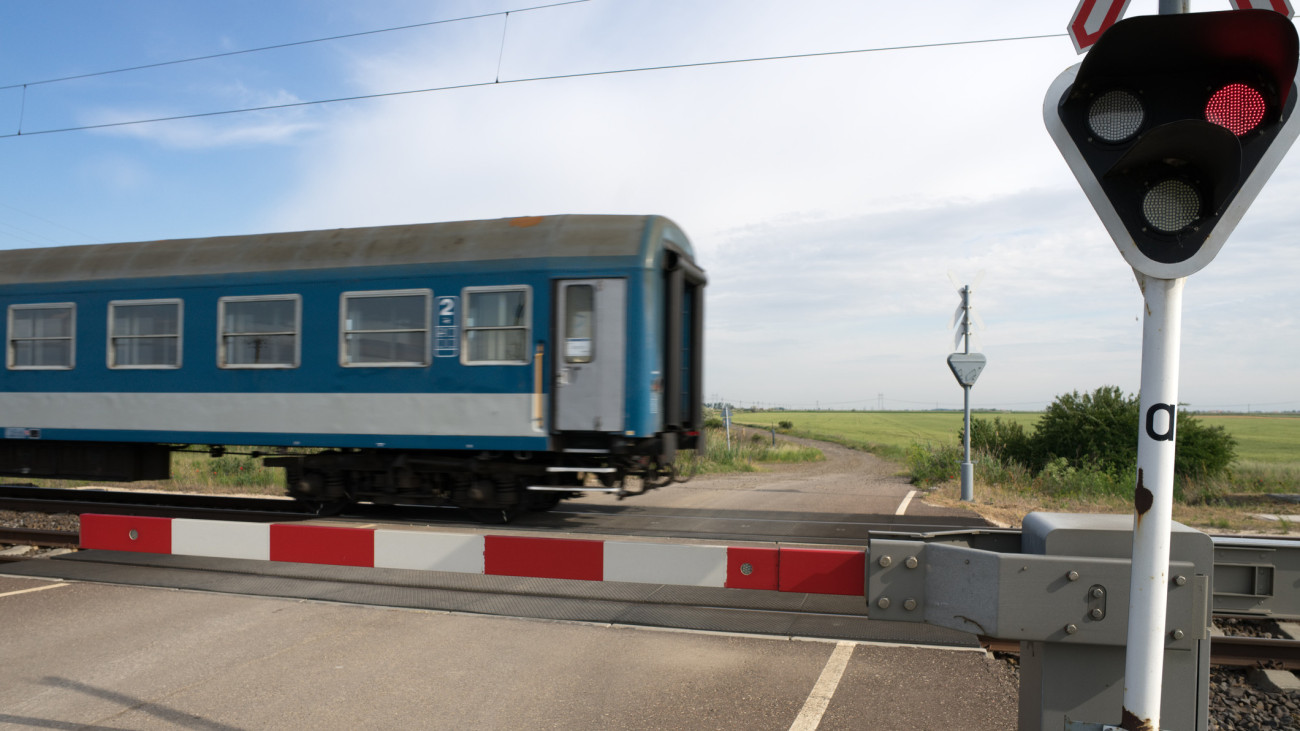 a modern intercity train go through a railway crossing