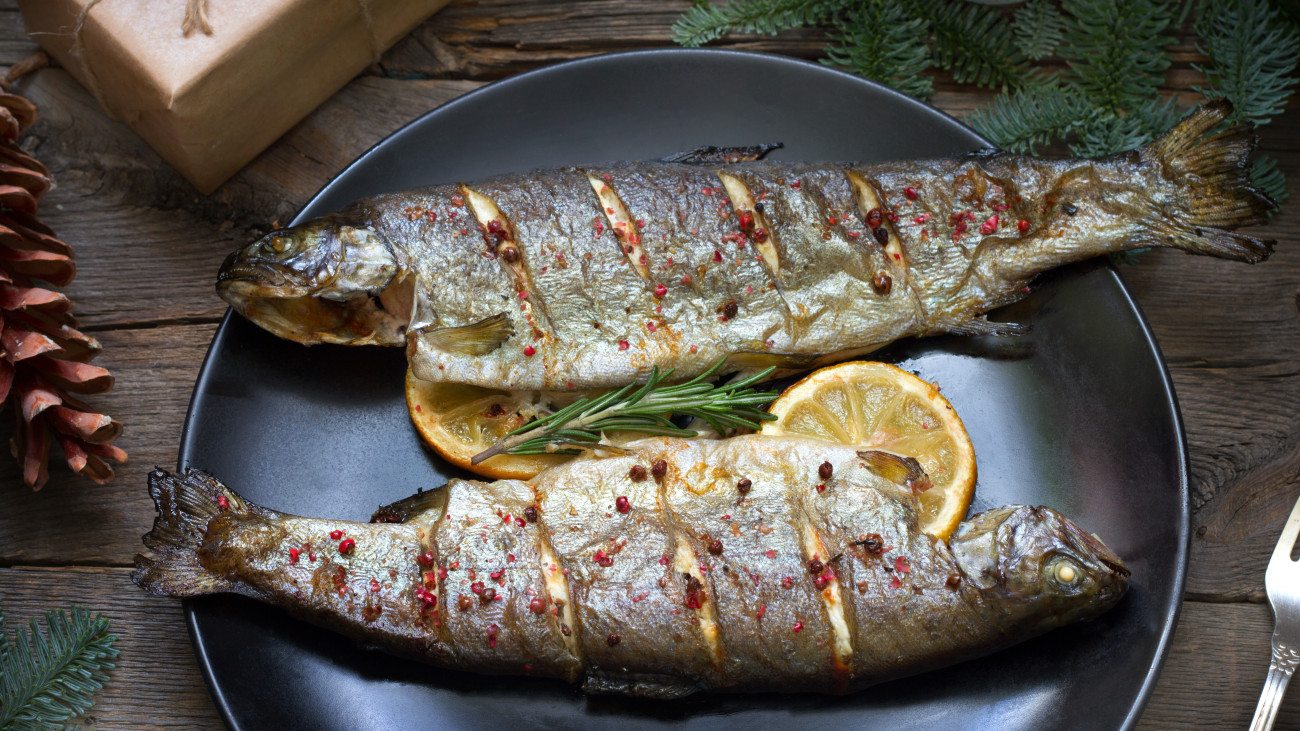 Christmas trout baked fish on table with ornament